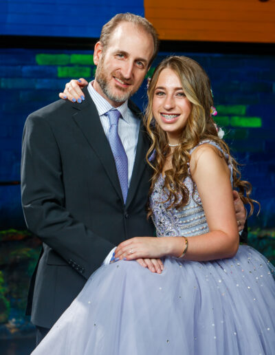 Father and daughter pose beautifully together with big smiles during a Bat Mitzvah celebration at Beat Street in Huntingdon Valley, Pennsylvania.
