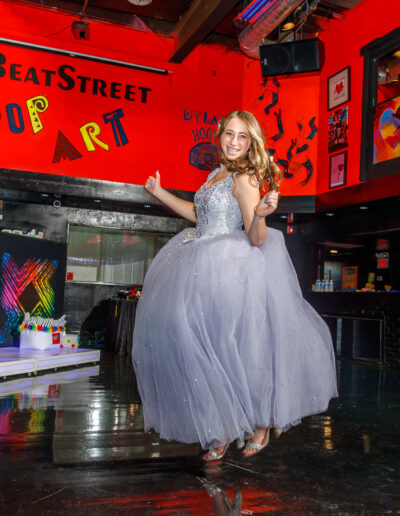 Bat mitzvah girl jumping with excitement on the dance floor at Beat Street Huntingdon Valley, PA