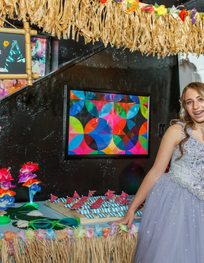 Tropical-themed bat mitzvah decor with flowers, flip-flops, and bright colors at Beat Street in Huntingdon Valley, PA