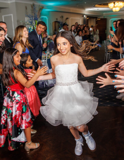 Bat mitzvah girl making her grand entrance surrounded by cheering guests and family during her event at Philmont Country Club in Philadelphia, photographed by PCSI PHOTO.