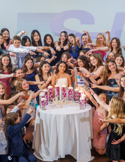 Bat mitzvah girl surrounded by friends during her candle lighting ceremony at Philmont Country Club in Philadelphia, captured by PCSI PHOTO.