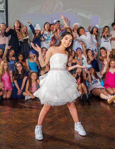 Bat mitzvah girl posing playfully with her friends on the dance floor during her event at Philmont Country Club in Philadelphia, photographed by PCSI PHOTO.