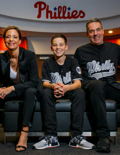 Bar Mitzvah boy so happy in the moment in the Phillies locker room with mom and dad