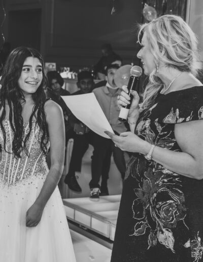 Artistic black and white photo of Bat Mitzvah girl attentively listening to her mother deliver heartfelt speech during celebration at Vie by Cescaphe in Philly