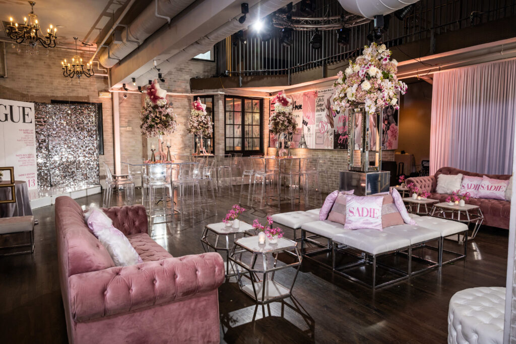 interior ballroom photography during a bat mitzvah at platform thirty in philadelphia that showcases a pink couch, elegant floral arrangements and clear high top furniture
