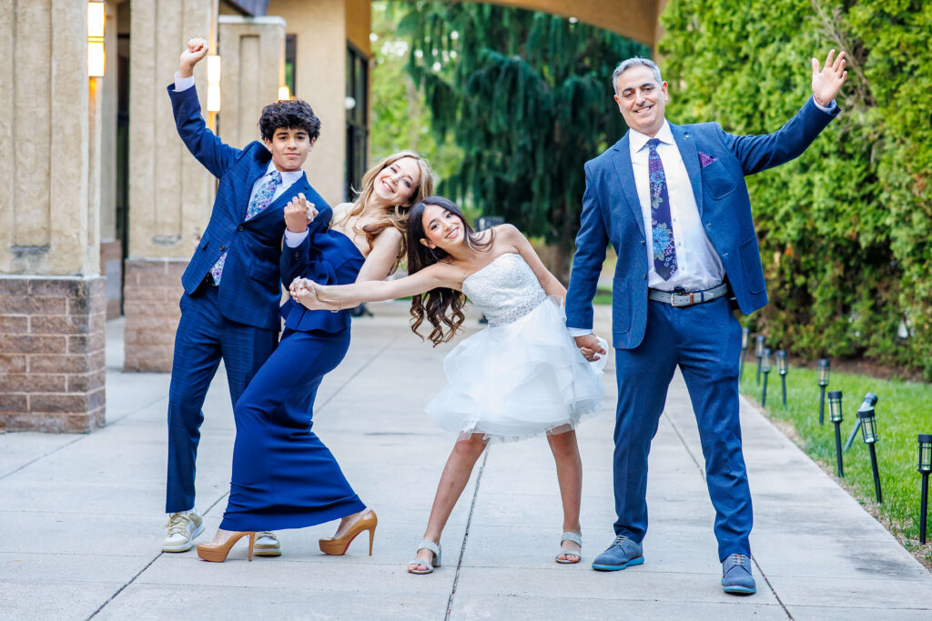 family of four posing outside for candid portraits at shir ami during service rehearsal photography